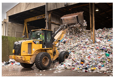 Waste being lifted by a digger