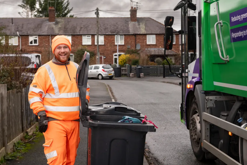 A CWR loader collects a bin with a smile
