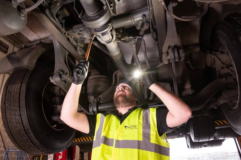 A fitter works under an HGV